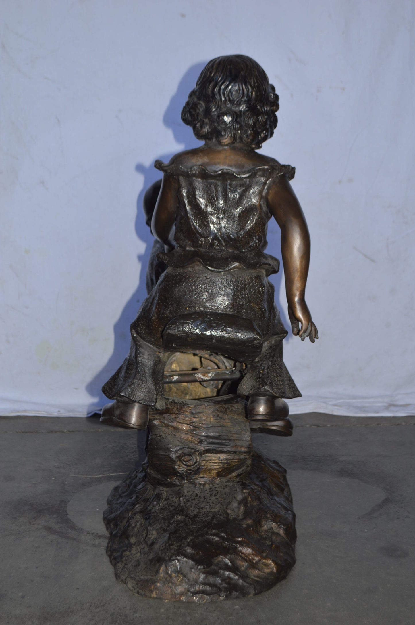 A Boy and a Girl Playing Seesaw Bronze Statue - Size: 17"L x 33"W x 36"H.