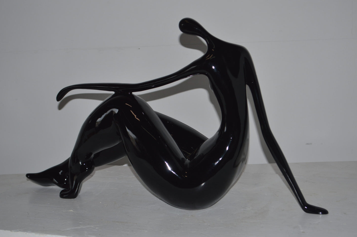 Modern Art Women on the Beach Black Resin Statue - Size: 28"L x 8"W x 16"H.