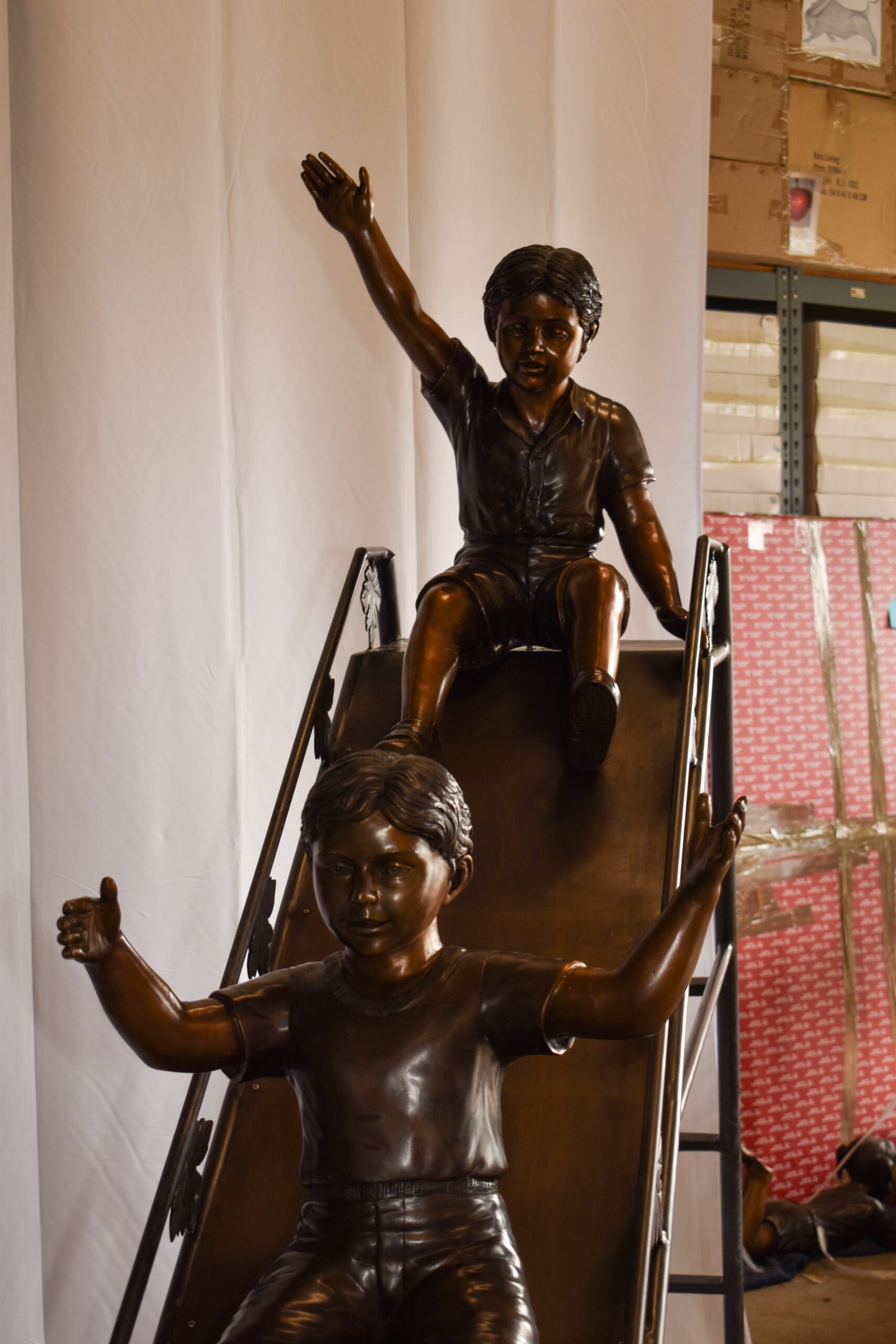 Lifsize Three kids playing on a slide bronze sculpture 114" x 18" x 83"H