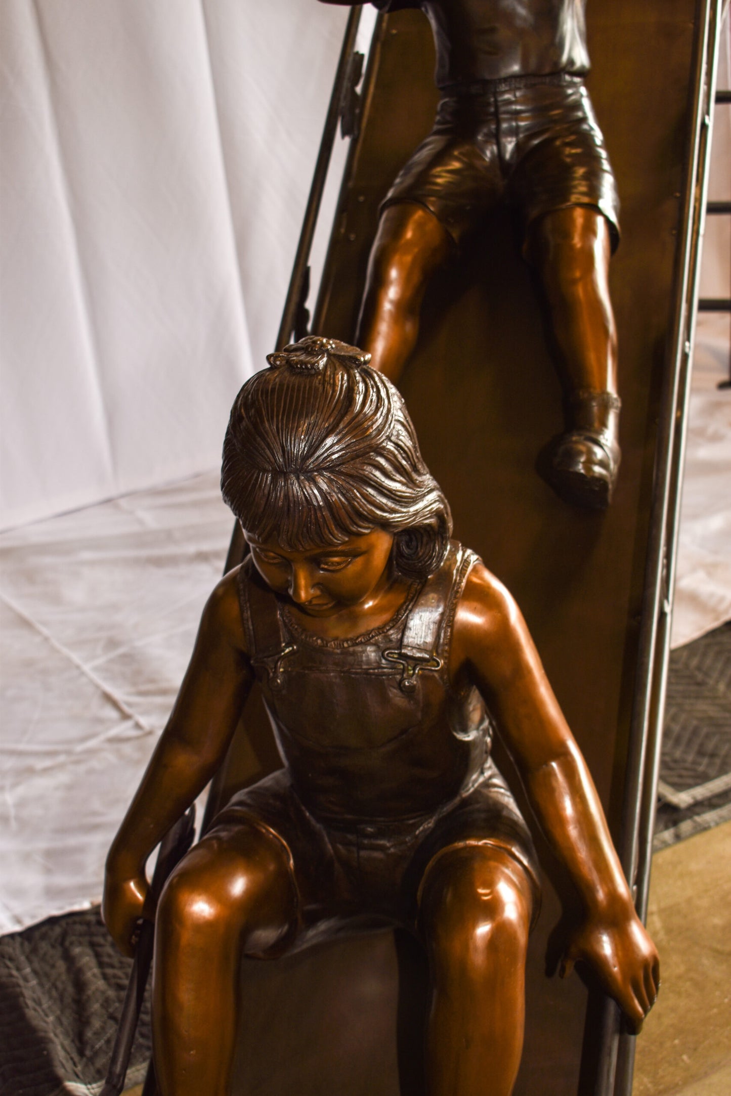 Lifsize Three kids playing on a slide bronze sculpture 114" x 18" x 83"H
