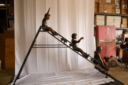 Lifsize Three kids playing on a slide bronze sculpture 114" x 18" x 83"H