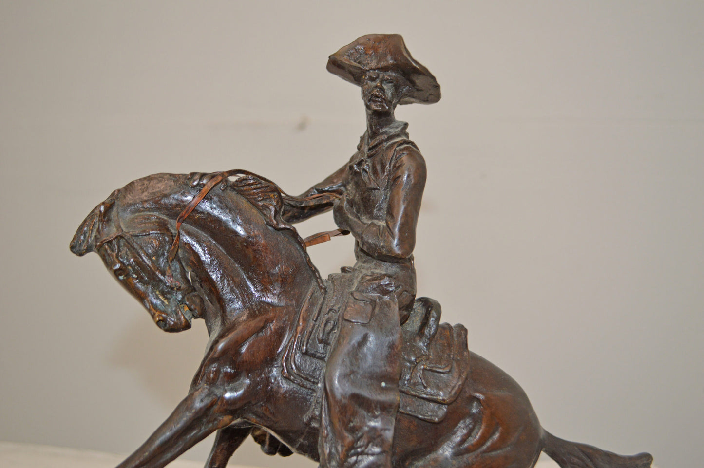 Cowboy, a Frederic Remington Replica Bronze Statue - Size: 14"L x 8"W x 13"H.