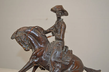 Cowboy, a Frederic Remington Replica Bronze Statue - Size: 14"L x 8"W x 13"H.