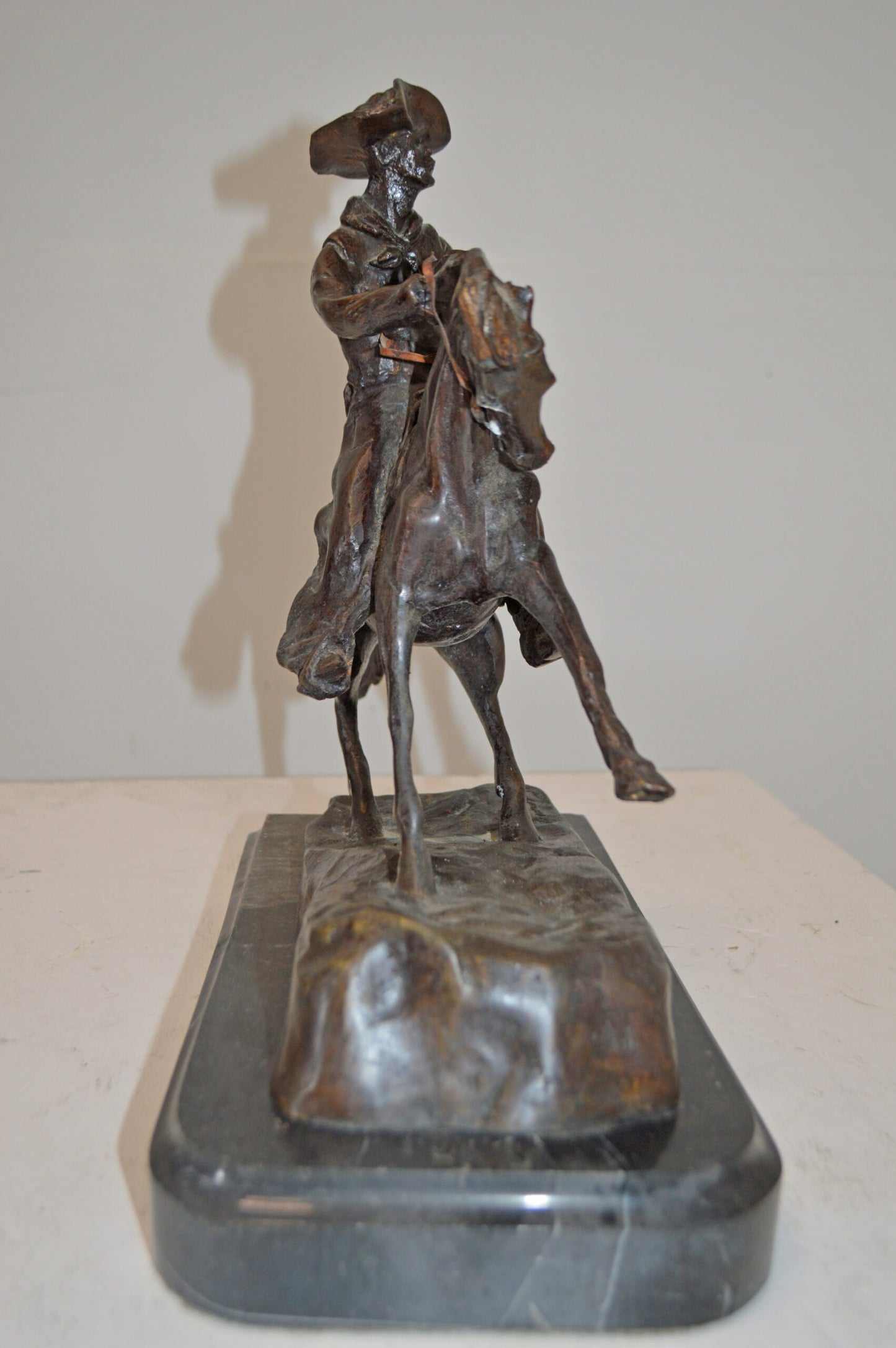Cowboy, a Frederic Remington Replica Bronze Statue - Size: 14"L x 8"W x 13"H.