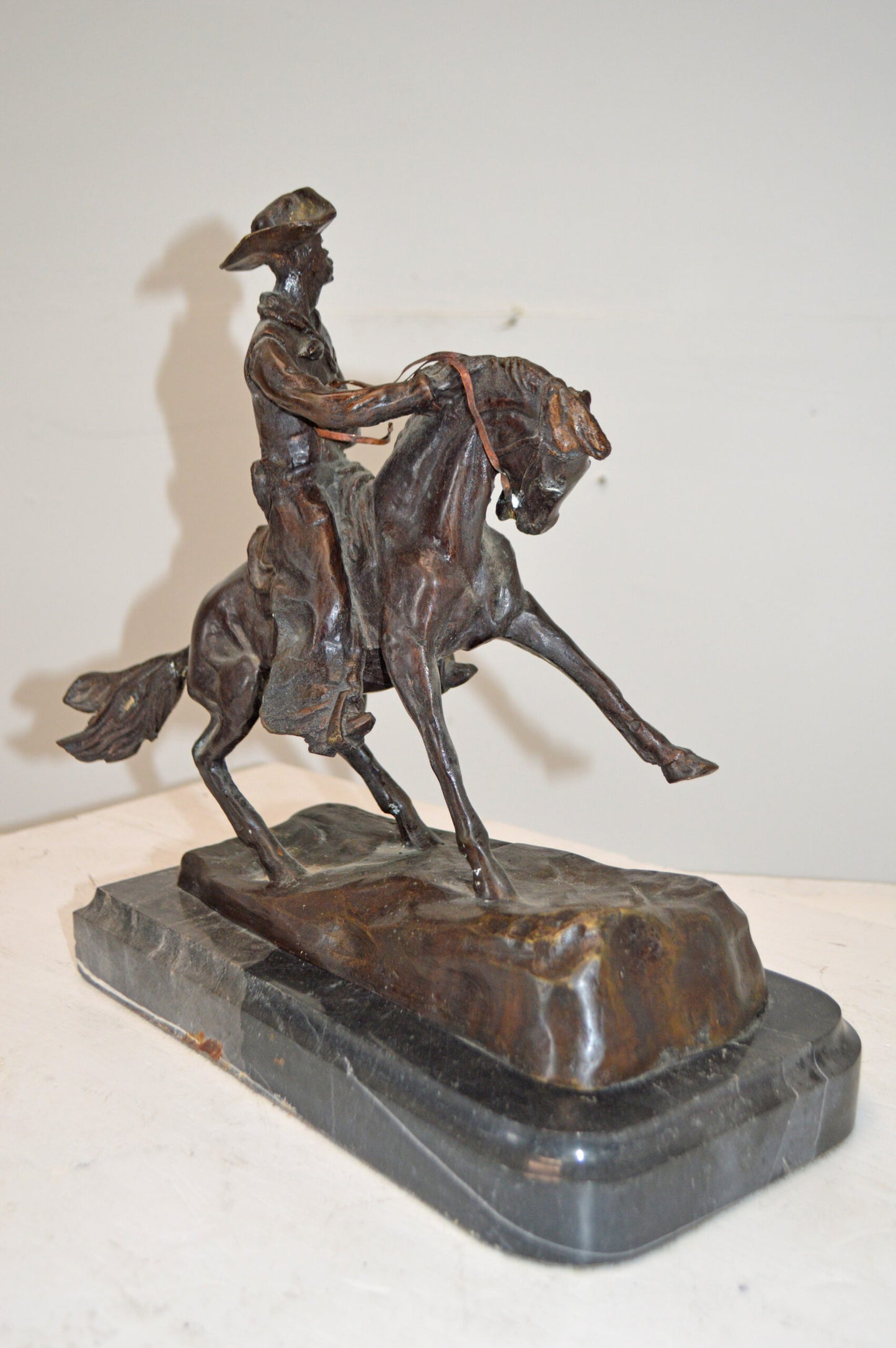 Cowboy, a Frederic Remington Replica Bronze Statue - Size: 14"L x 8"W x 13"H.