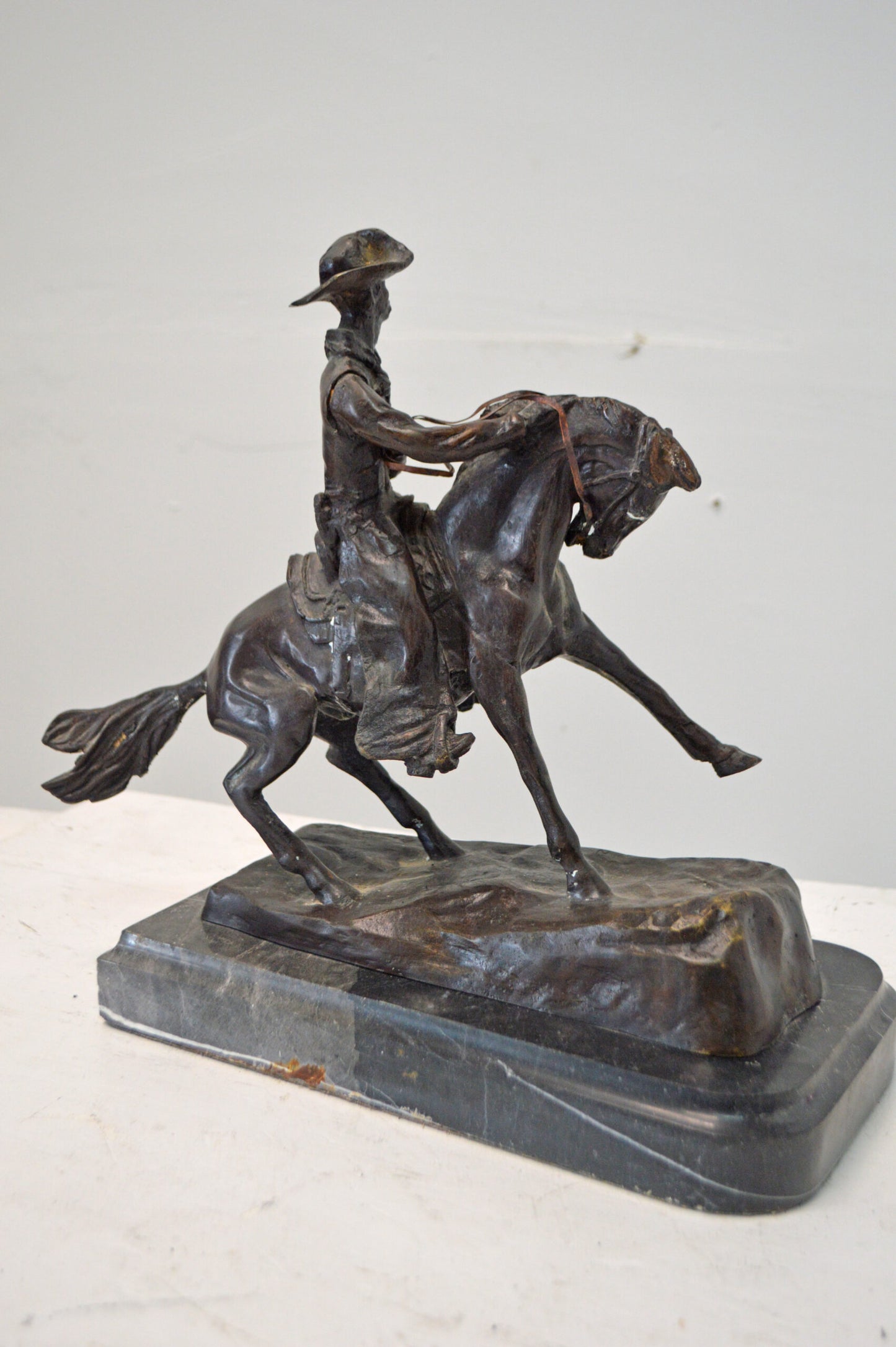 Cowboy, a Frederic Remington Replica Bronze Statue - Size: 14"L x 8"W x 13"H.