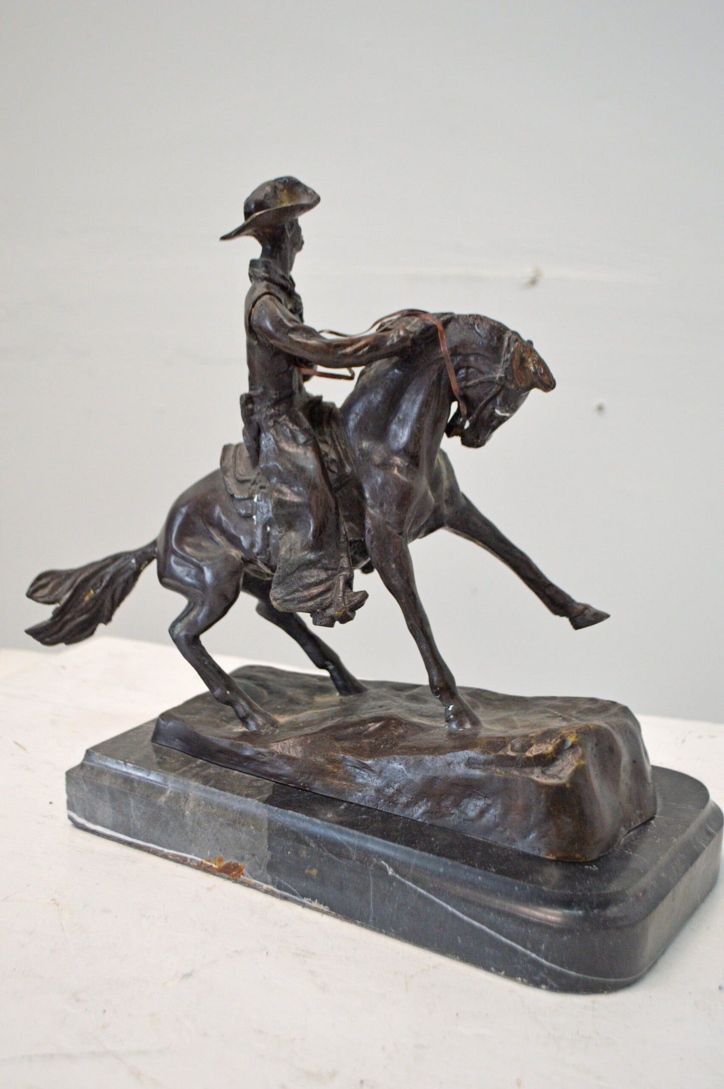 Cowboy, a Frederic Remington Replica Bronze Statue - Size: 14"L x 8"W x 13"H.
