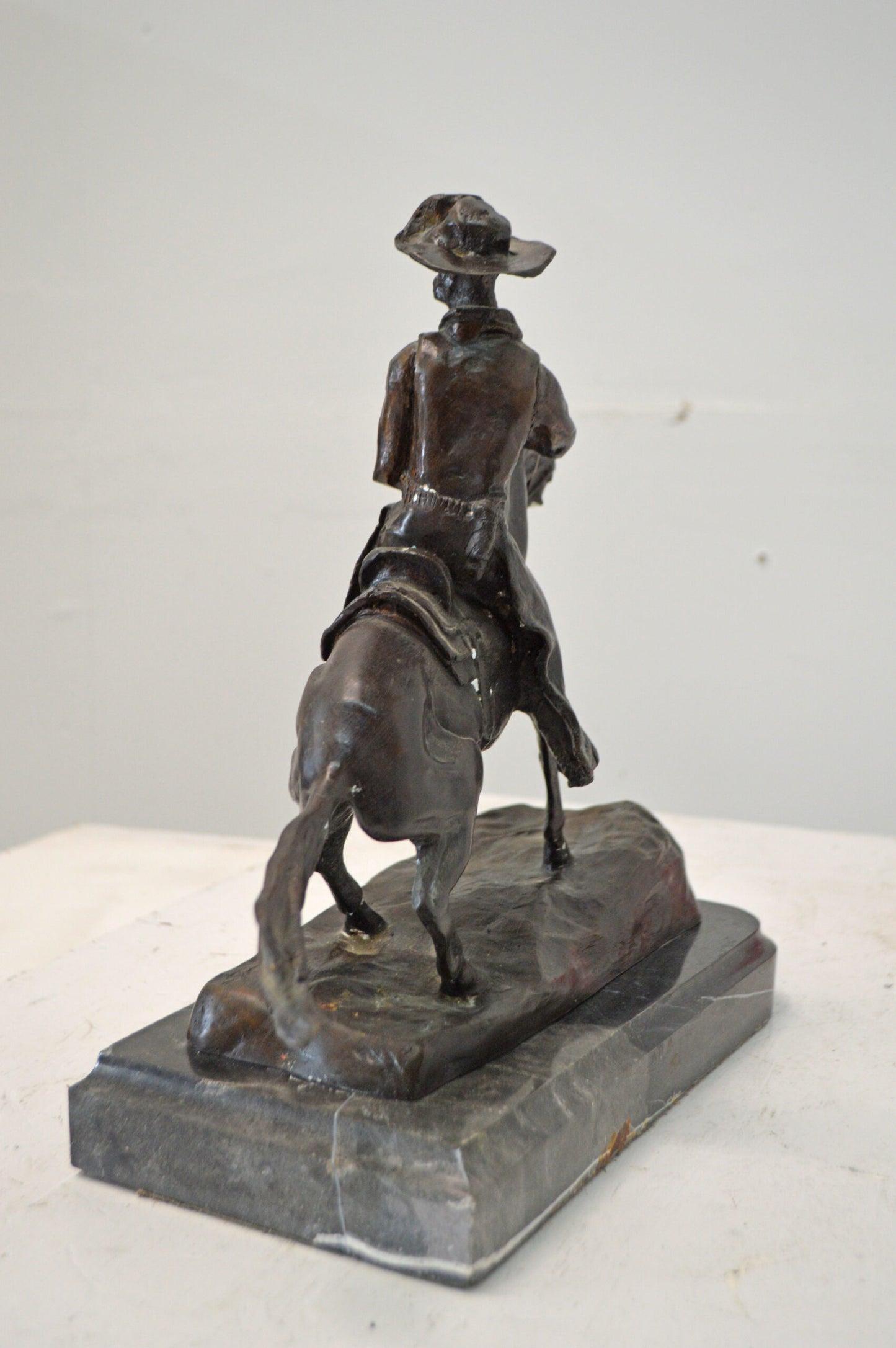 Cowboy, a Frederic Remington Replica Bronze Statue - Size: 14"L x 8"W x 13"H.