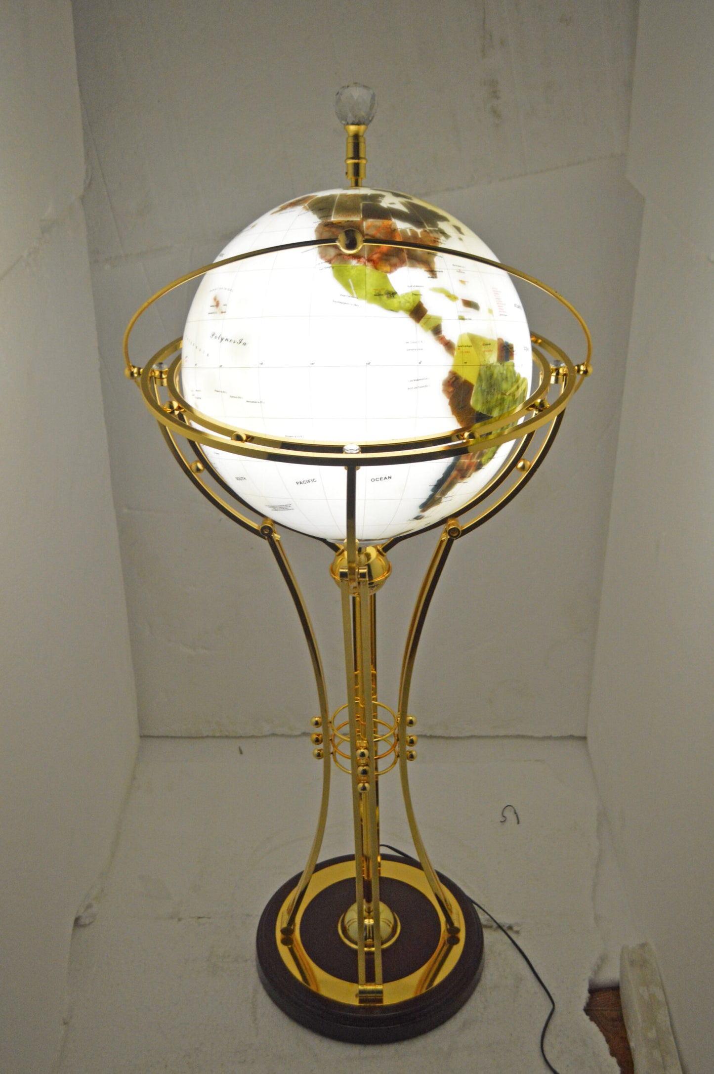 Illuminated White Gold World Globe Rotated by motor - Size: 19"L x 19"W x 42"H.