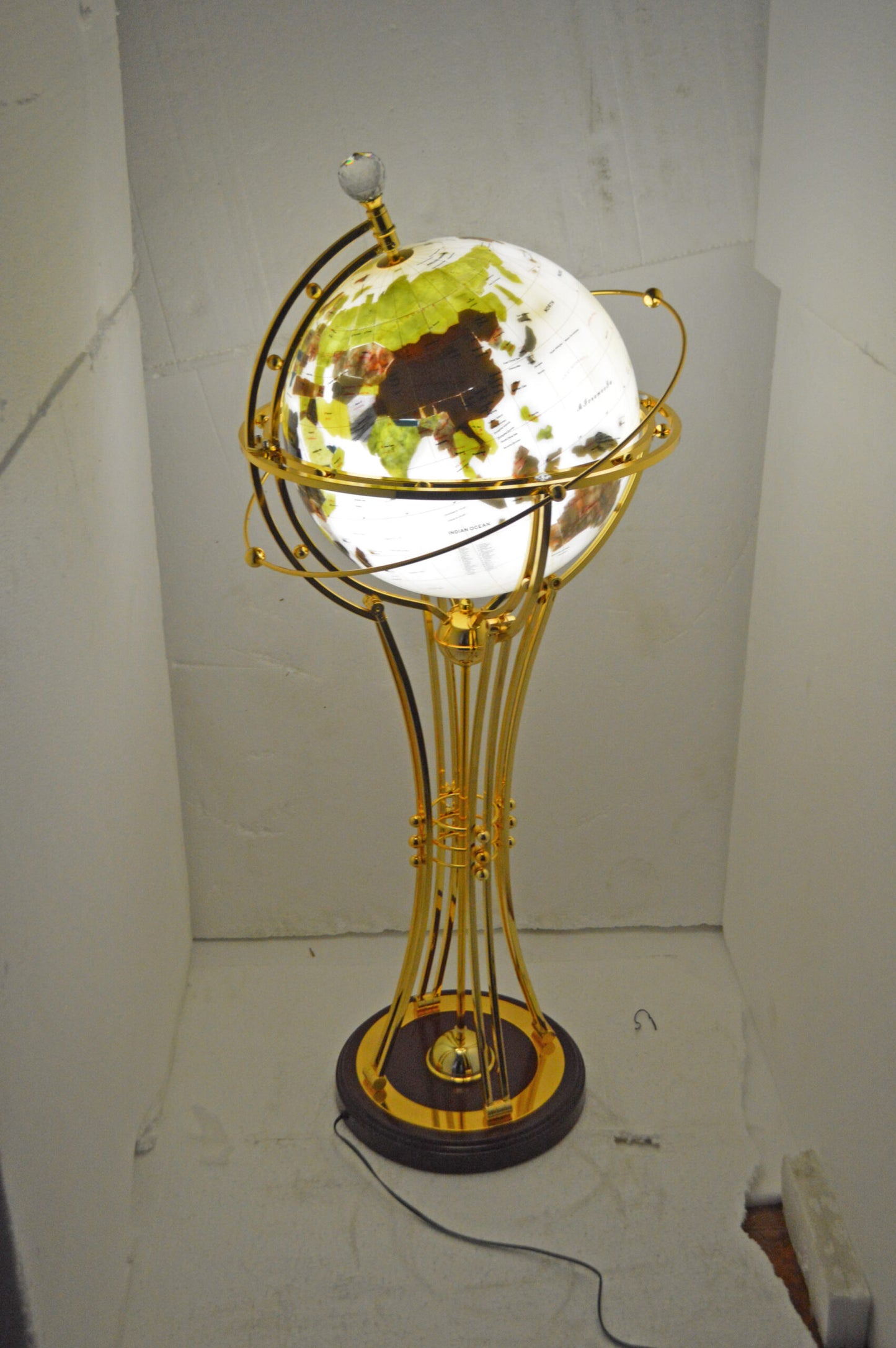 Illuminated White Gold World Globe Rotated by motor - Size: 19"L x 19"W x 42"H.
