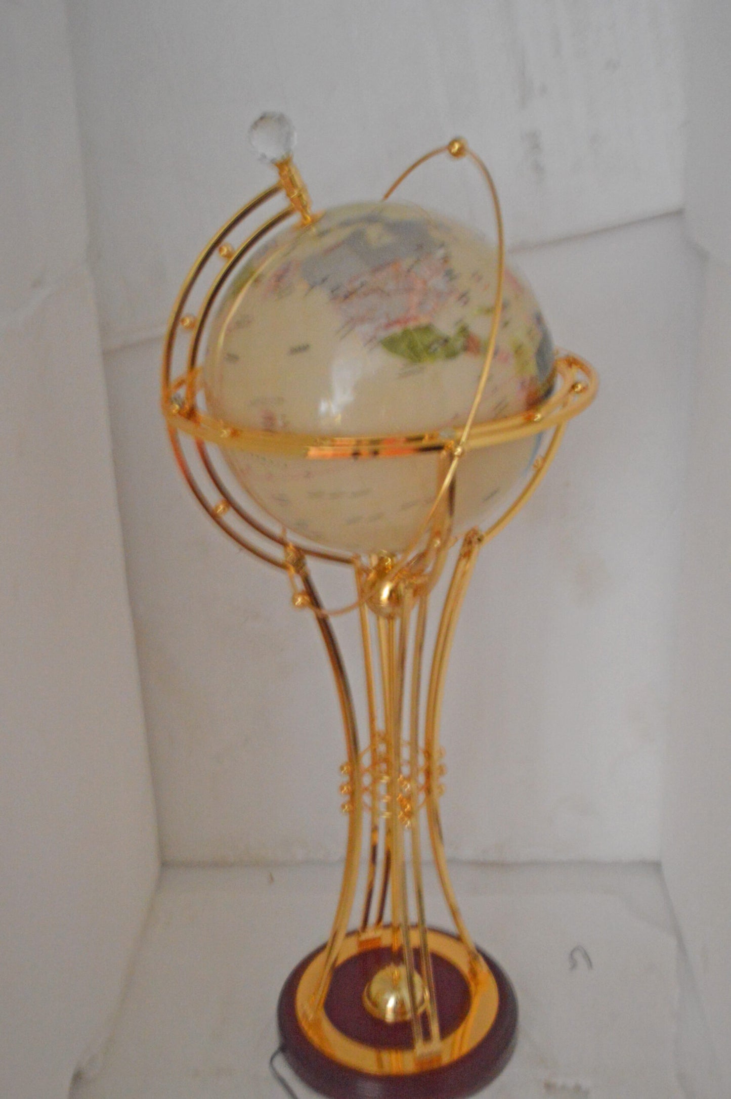 Illuminated White Gold World Globe Rotated by motor - Size: 19"L x 19"W x 42"H.
