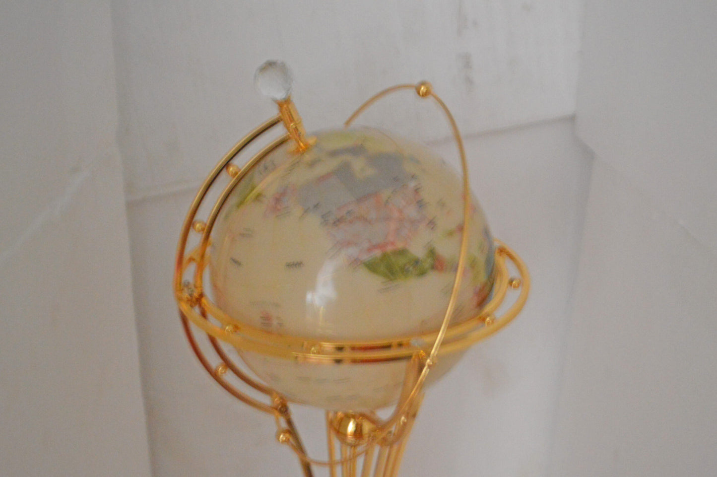 Illuminated White Gold World Globe Rotated by motor - Size: 19"L x 19"W x 42"H.