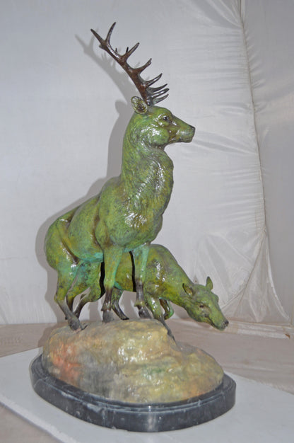 Two Deers Bronze Statue with a Green patina finish - Size: 15"L x 22"W x 32"H.