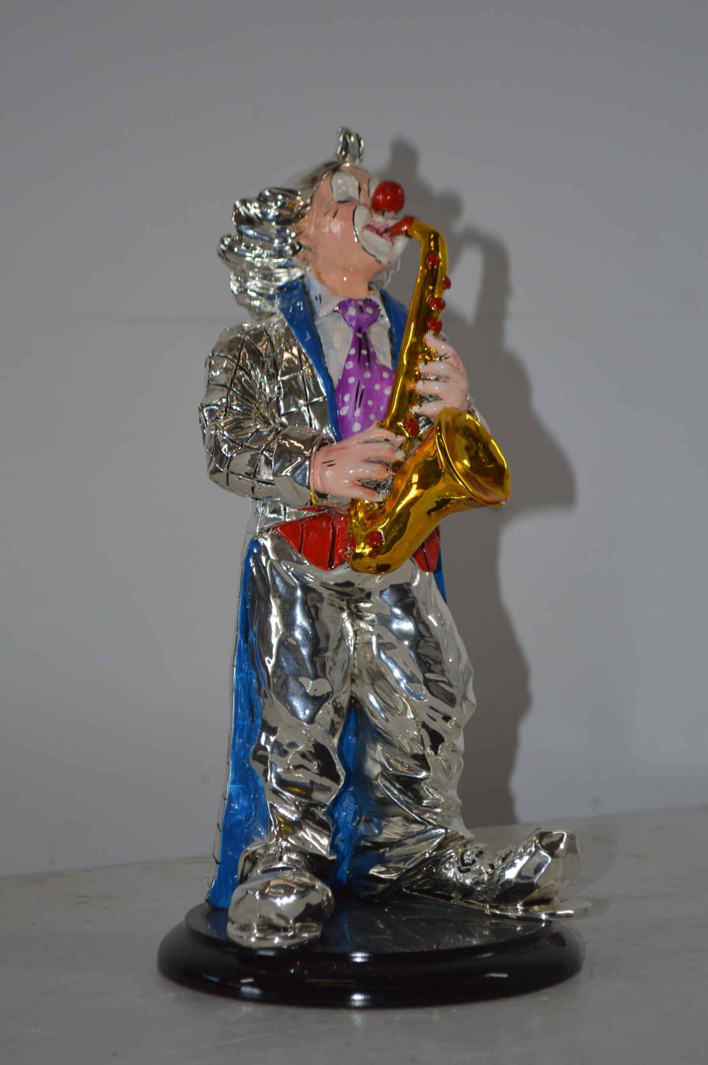 Clown Plays the Saxophone Resin Statue Silver finish - Size: 6"L x 6"W x 14"H.