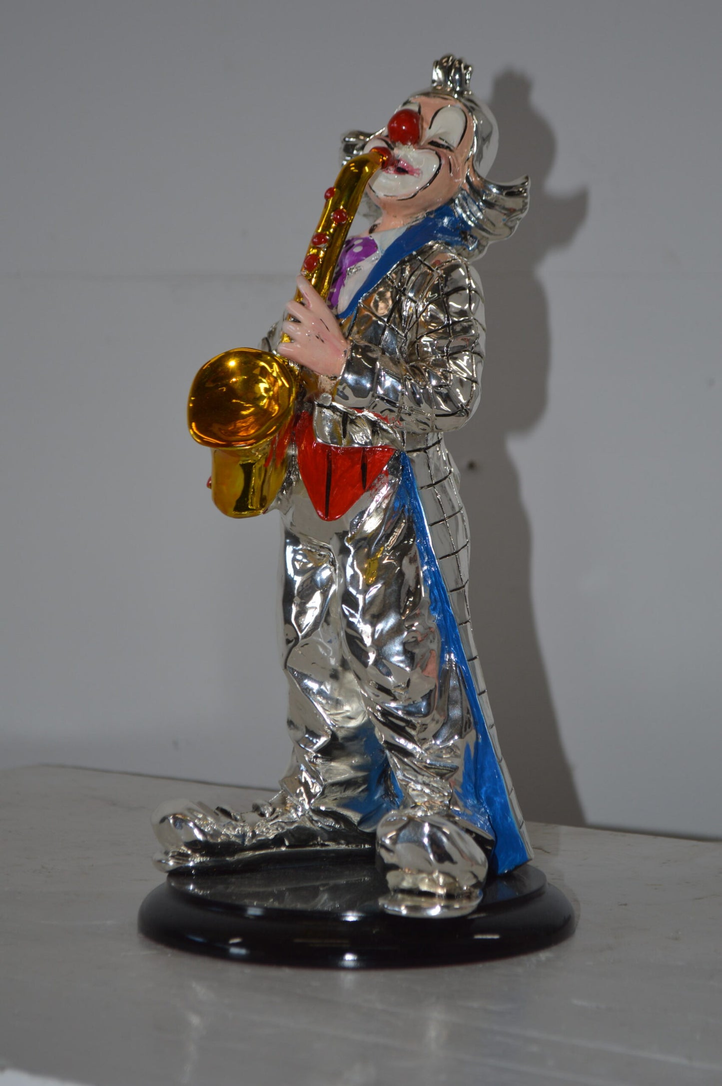 Clown Plays the Saxophone Resin Statue Silver finish - Size: 6"L x 6"W x 14"H.