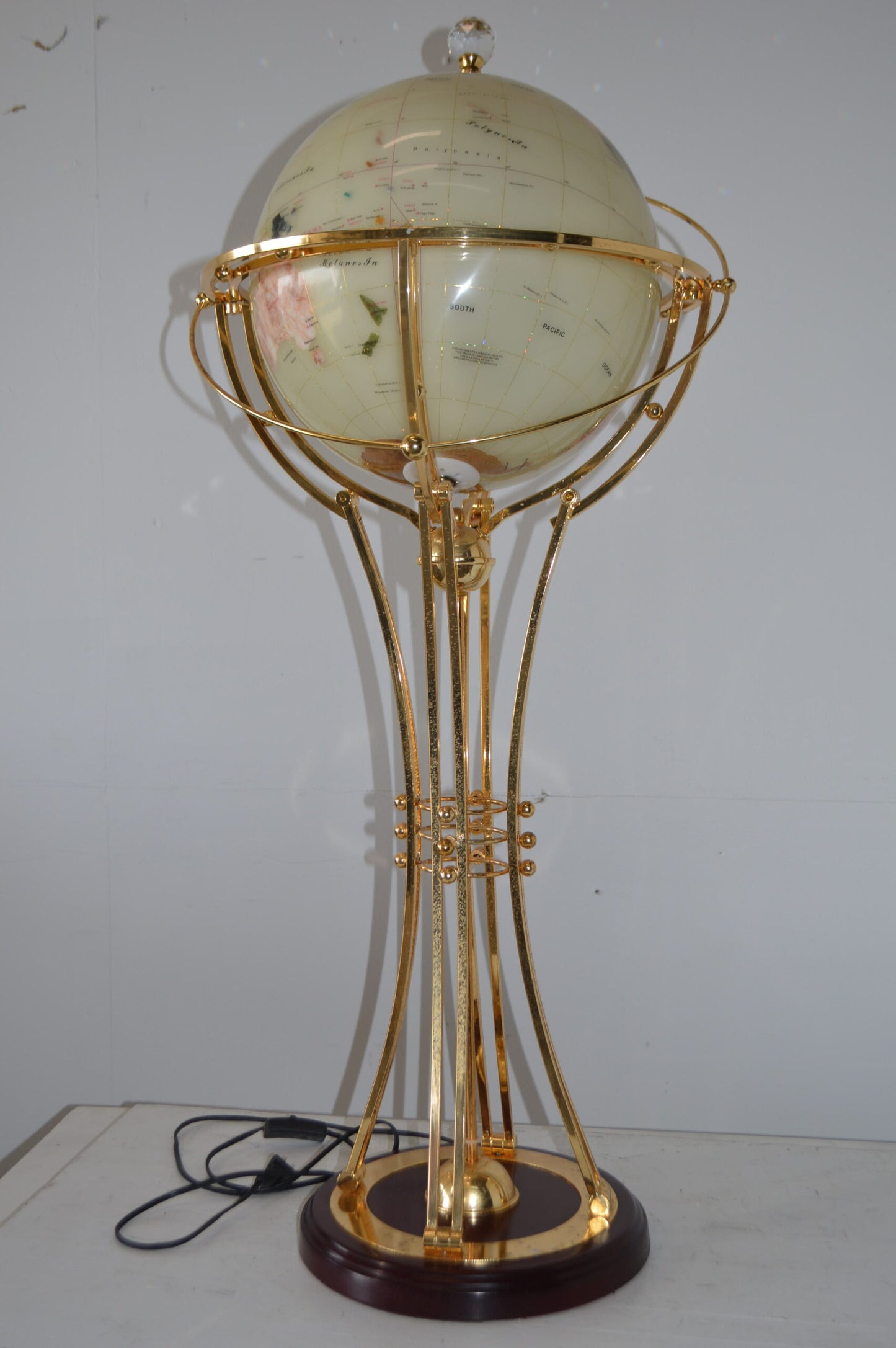 Illuminated White Gold World Globe Rotated by motor - Size: 19"L x 19"W x 42"H.
