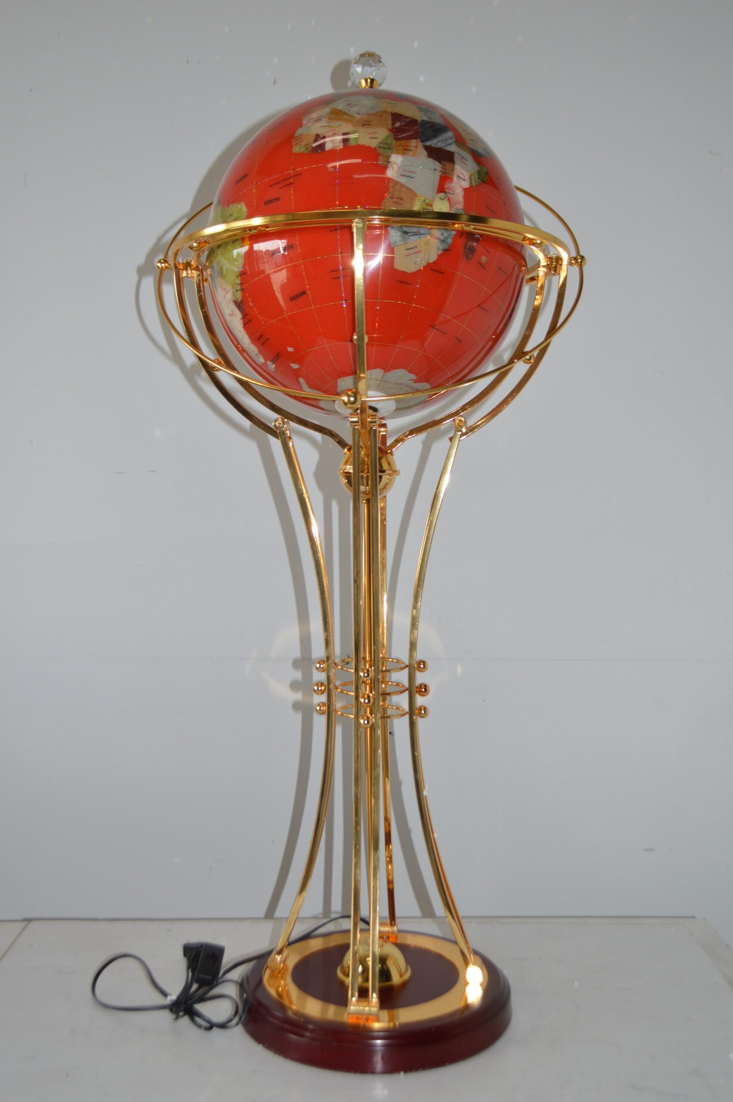 Illuminated Red - Gold World Globe Rotated by motor - Size: 19"L x 19"W x 42"H.