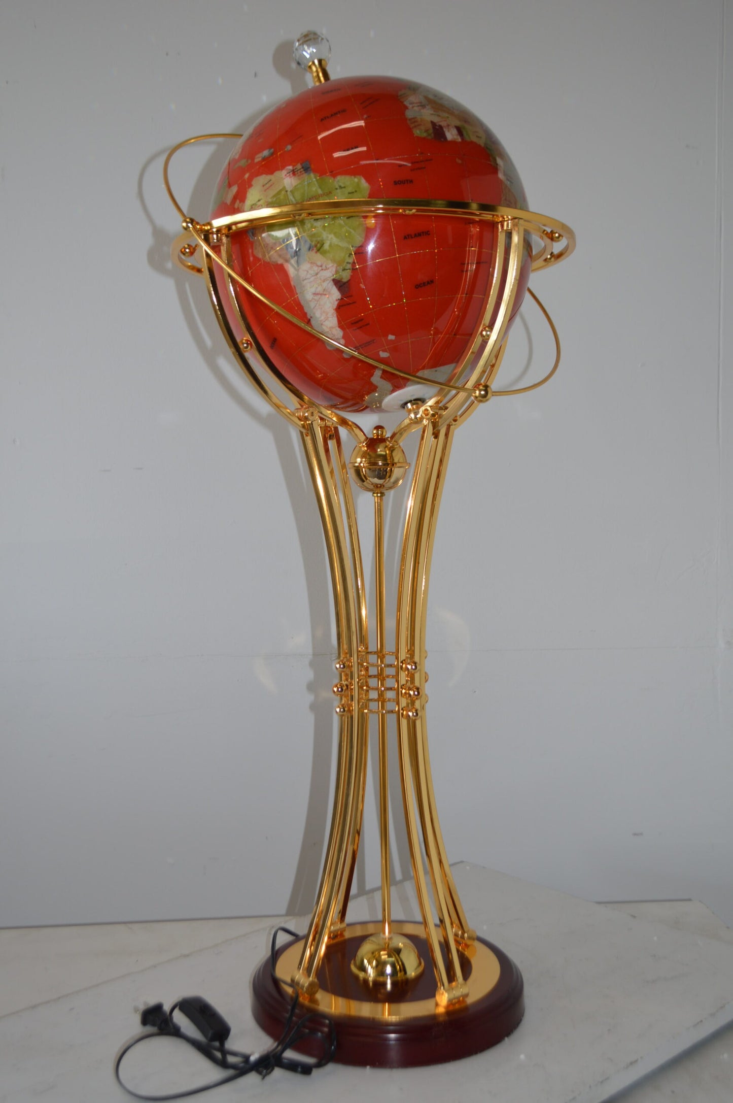 Illuminated Red - Gold World Globe Rotated by motor - Size: 19"L x 19"W x 42"H.