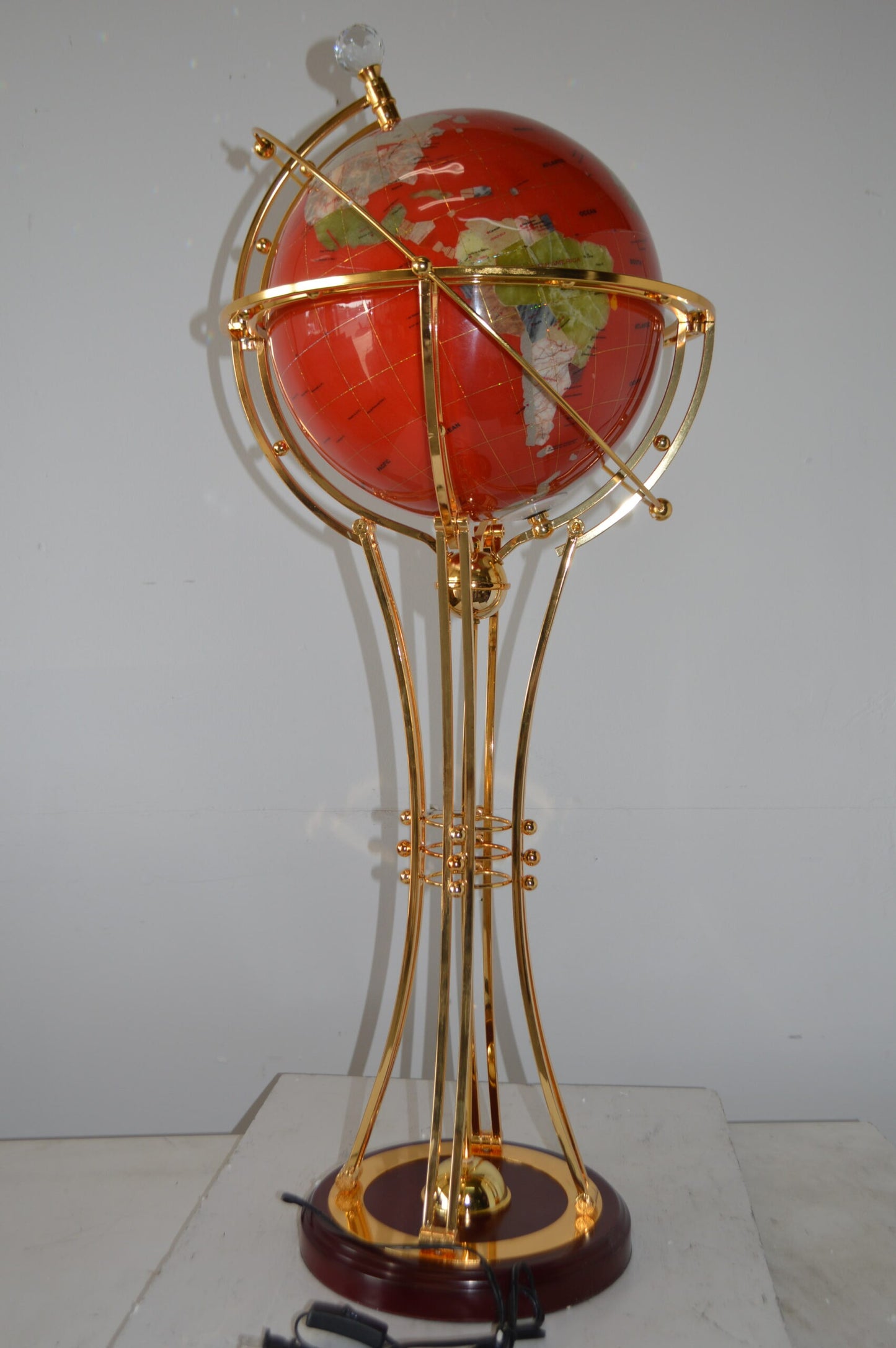 Illuminated Red - Gold World Globe Rotated by motor - Size: 19"L x 19"W x 42"H.