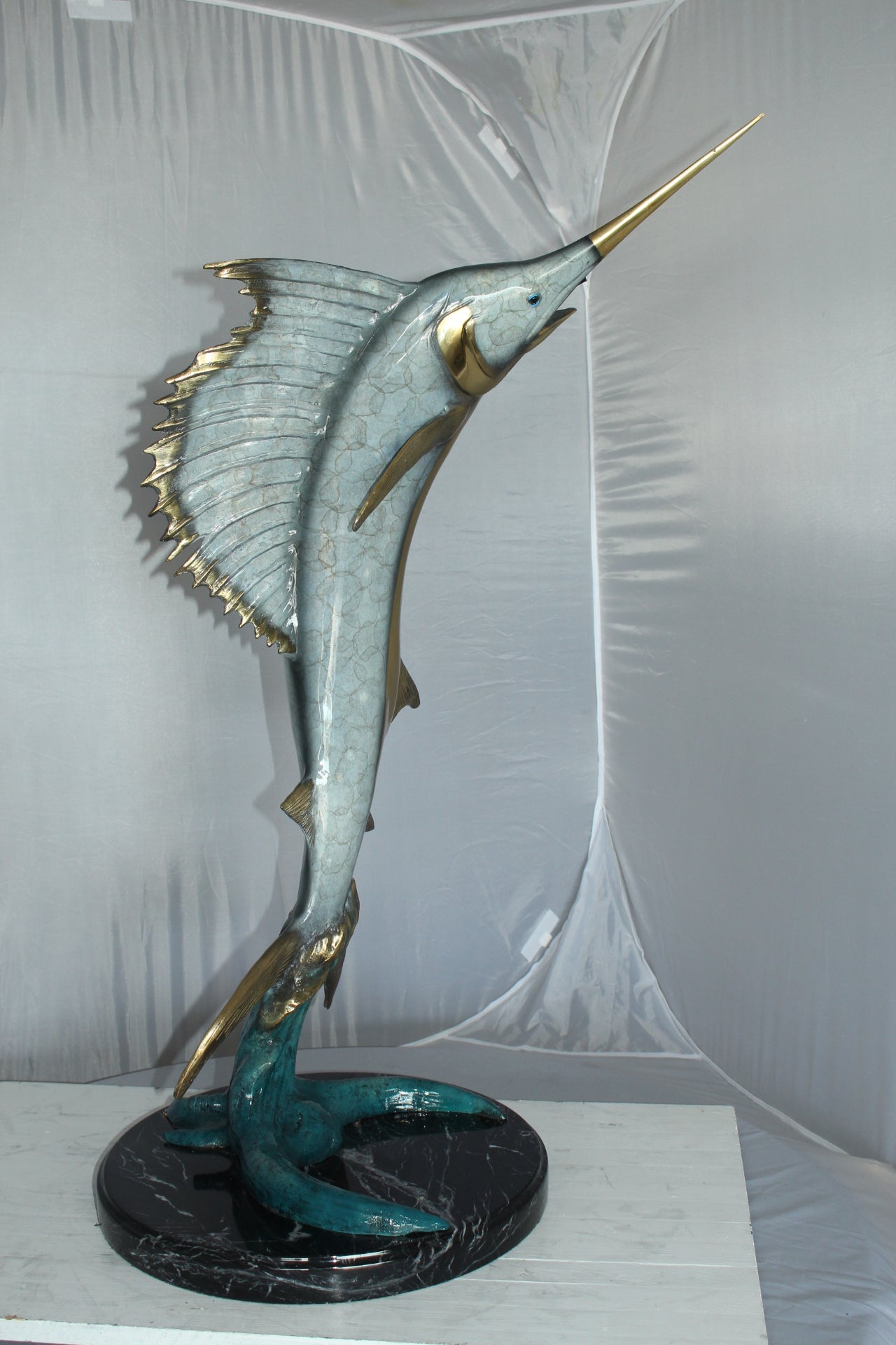One Sailfish Jumping of the ware - Bronze Statue -  Size: 16"L x 16"W x 39"H. 