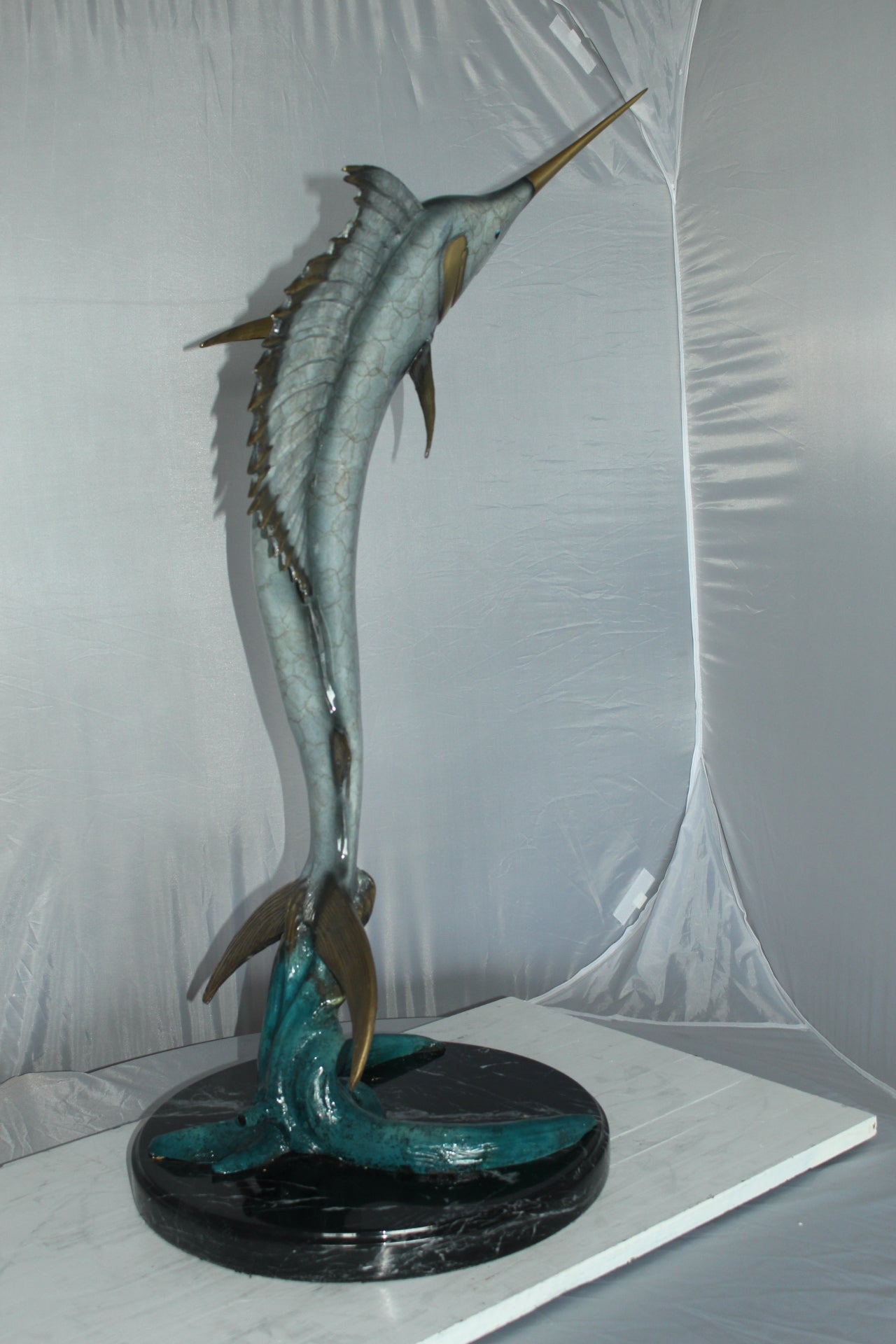 One Sailfish Jumping of the ware - Bronze Statue -  Size: 16"L x 16"W x 39"H. 
