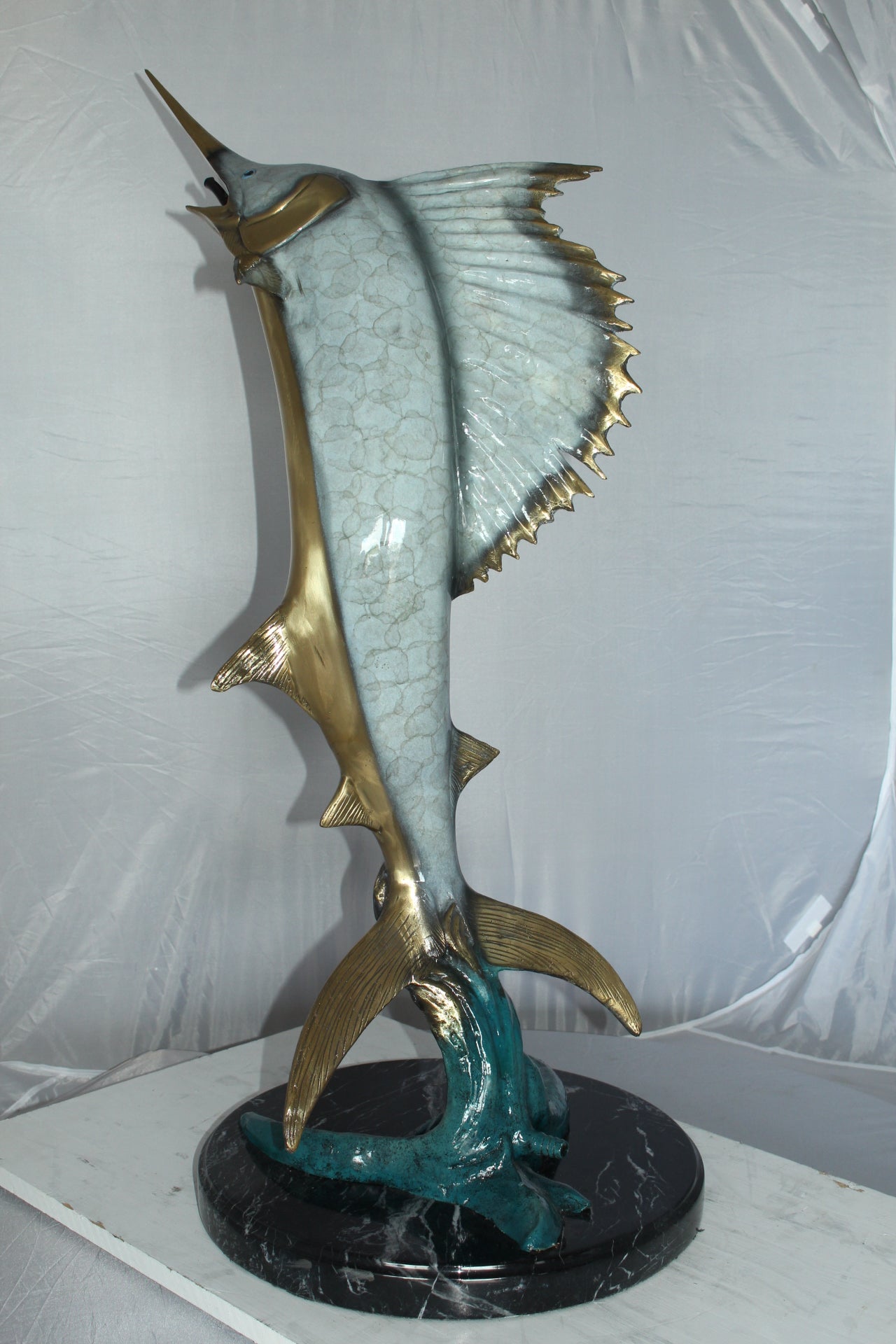 One Sailfish Jumping of the ware - Bronze Statue -  Size: 16"L x 16"W x 39"H. 