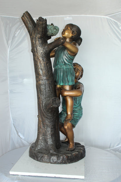 Two Kids Climbing on a Tree Bronze Statue -  Size: 17"L x 17"W x 46"H. 