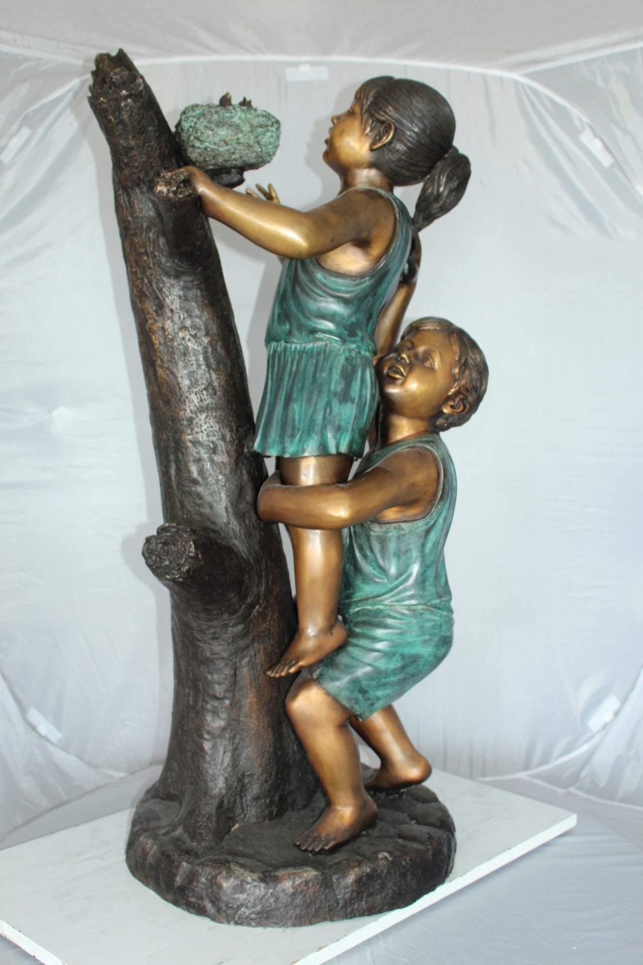 Two Kids Climbing on a Tree Bronze Statue -  Size: 17"L x 17"W x 46"H. 