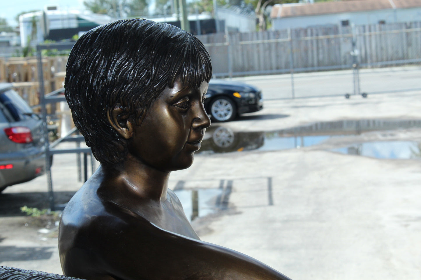A bear with a boy bronze statue -  Size: 39"L x 24"W x 32"H.
