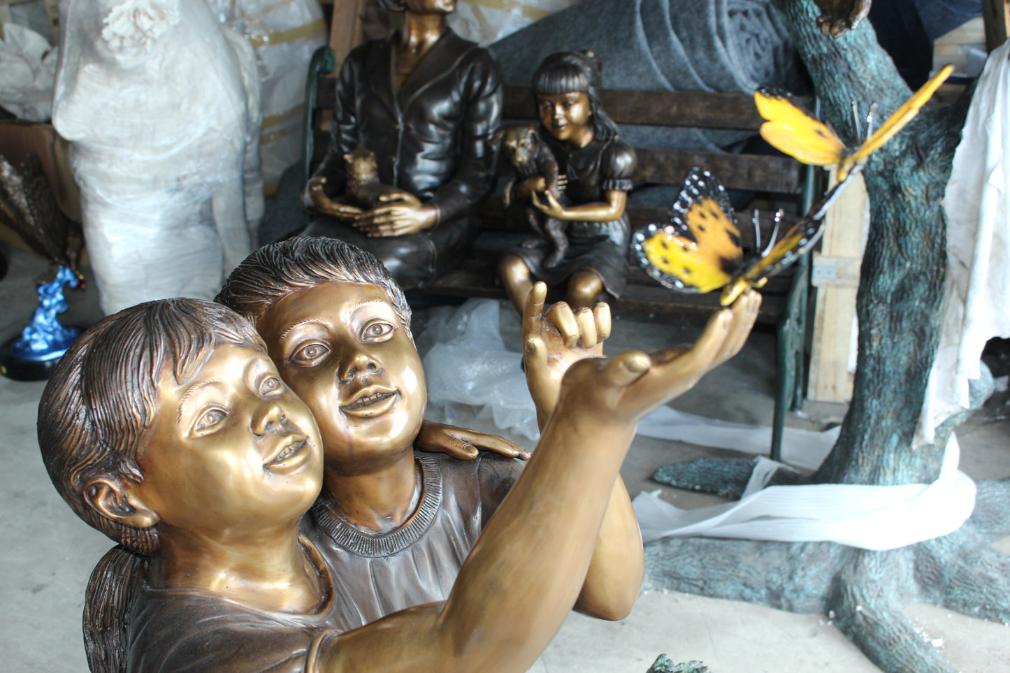 Two Kids Playing with Butterflies Bronze Statue -  Size: 30"L x 30"W x 50"H. 