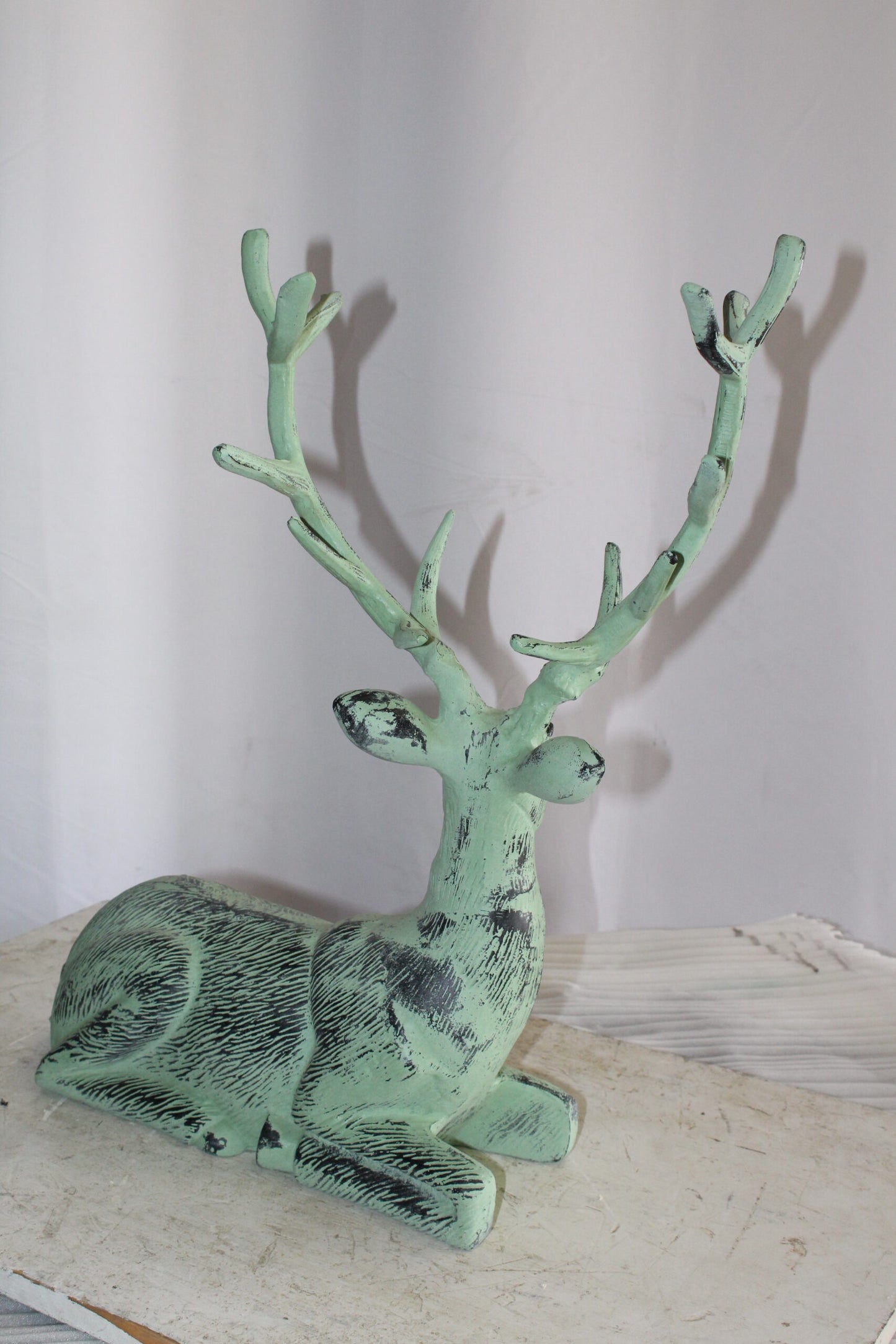 Aluminum Deer Statue Green Patina Resting on the ground 26" x 7" x 24"H