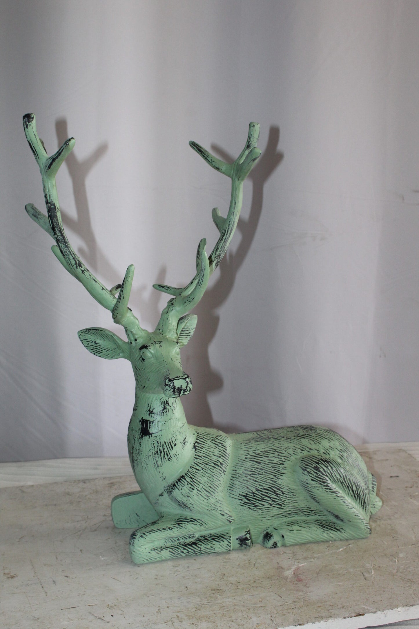 Aluminum Deer Statue Green Patina Resting on the ground 26" x 7" x 24"H