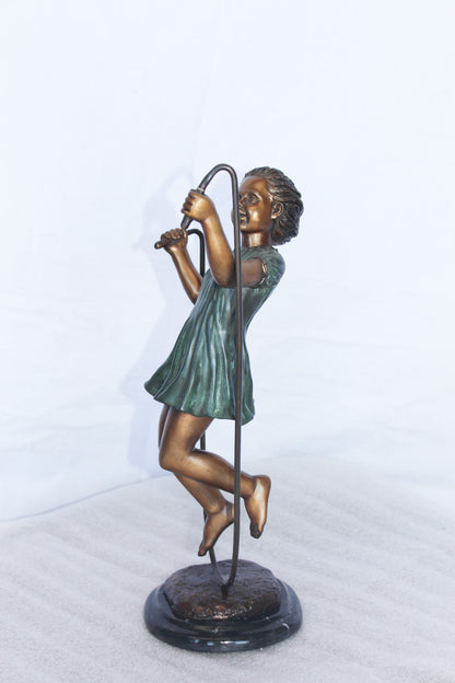 Young girl jump roping bronze statue -  Size: 5"L x 7"W x 15"H.