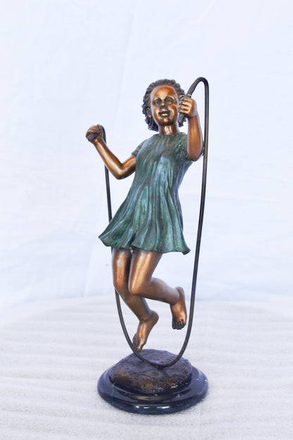 Young girl jump roping bronze statue -  Size: 5"L x 7"W x 15"H.