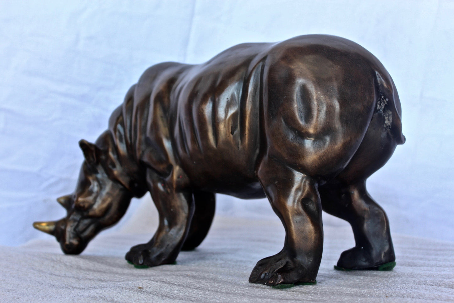 Relaxed Rhino bronze statue -  Size: 16"L x 9"W x 8"H.