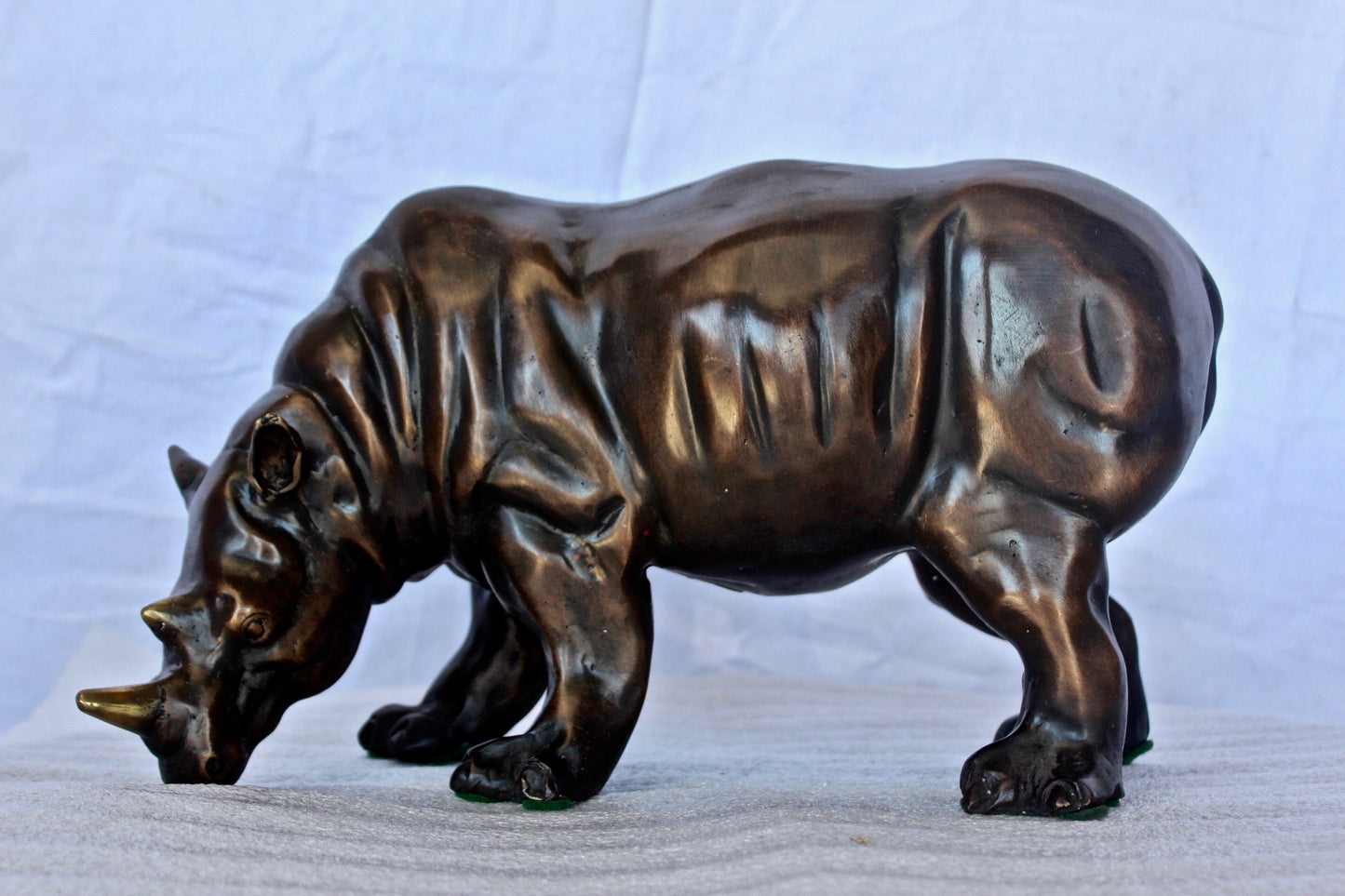 Relaxed Rhino bronze statue -  Size: 16"L x 9"W x 8"H.