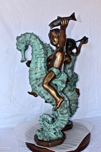 Boy and girl riding seahorses bronze fountain -  Size: 18"L x 23"W x 38"H.