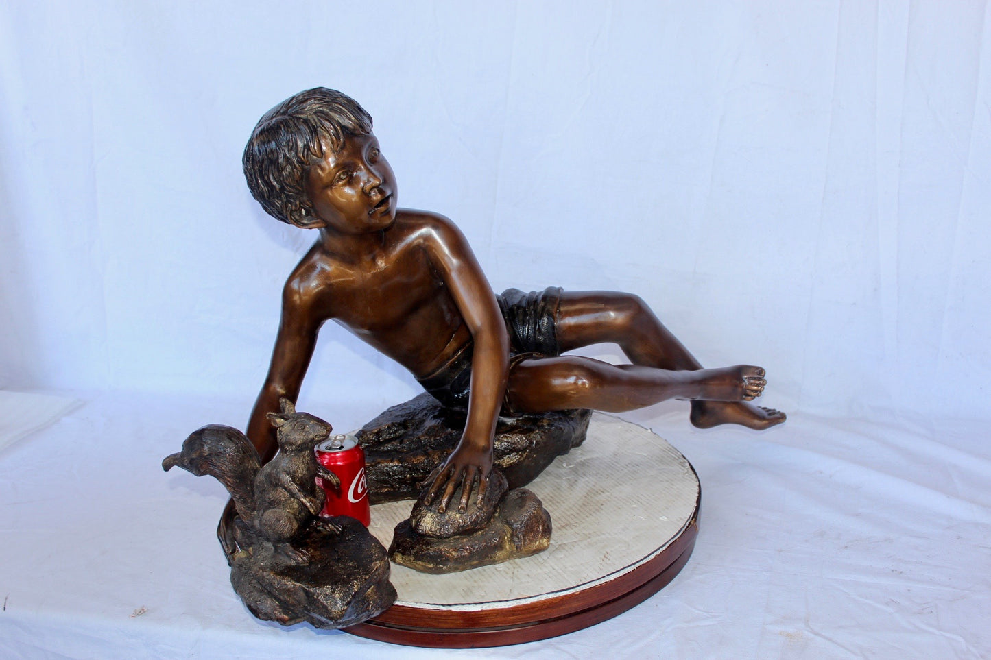 Adventurous boy with squirrel bronze statue -  Size: 36"L x 18"W x 22"H.
