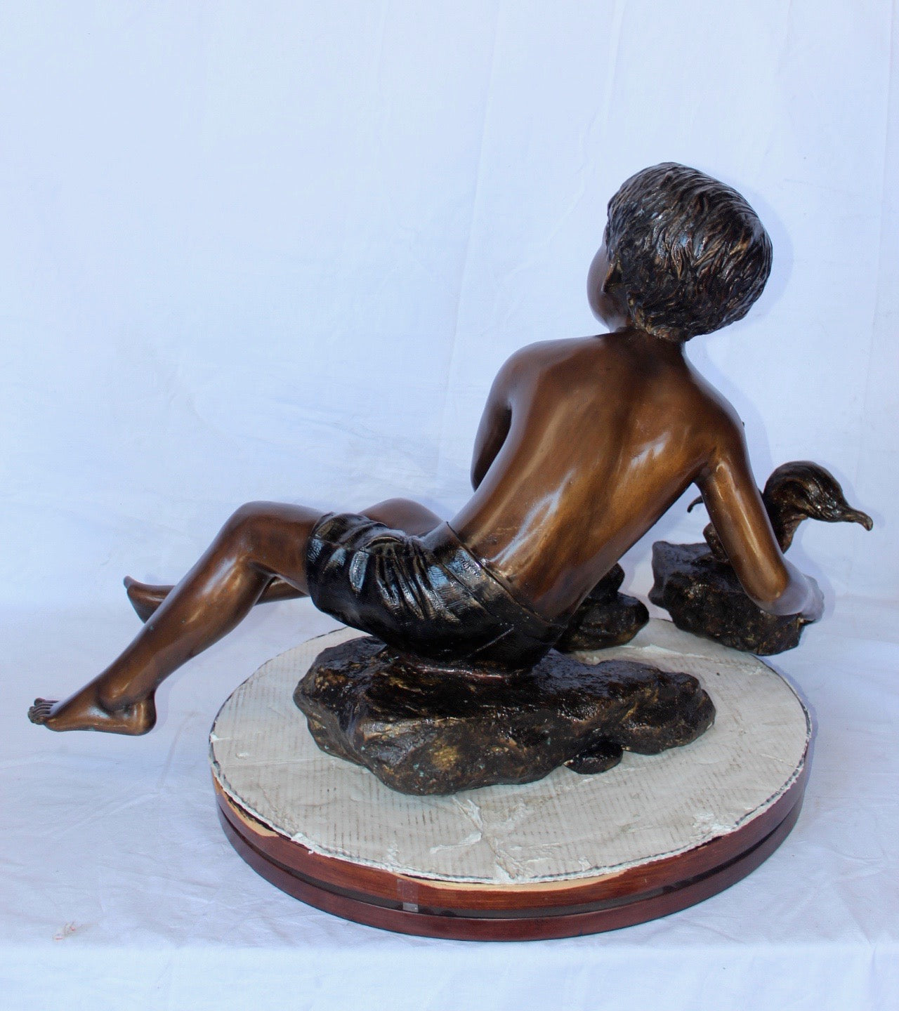Adventurous boy with squirrel bronze statue -  Size: 36"L x 18"W x 22"H.