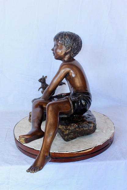 Adventurous boy with squirrel bronze statue -  Size: 36"L x 18"W x 22"H.