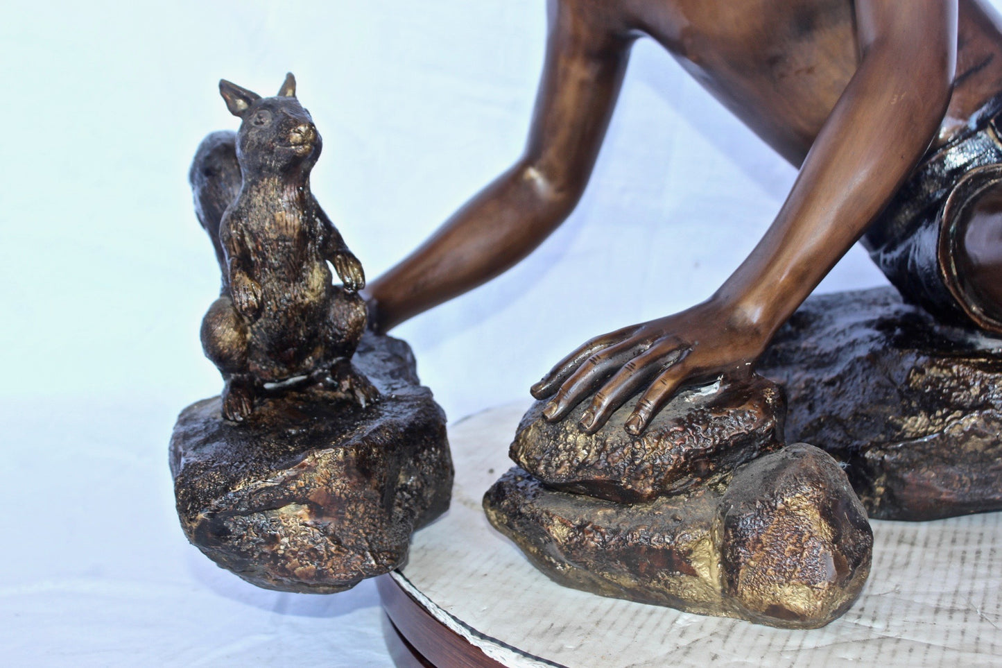 Adventurous boy with squirrel bronze statue -  Size: 36"L x 18"W x 22"H.