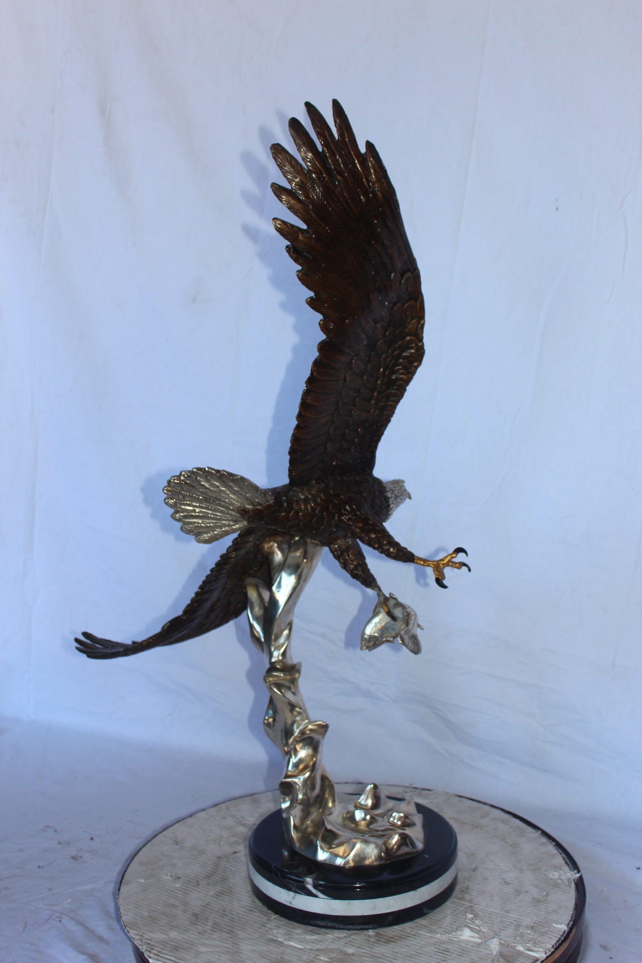 Soaring eagle carrying prey bronze statue -  Size: 16"L x 23"W x 39"H.