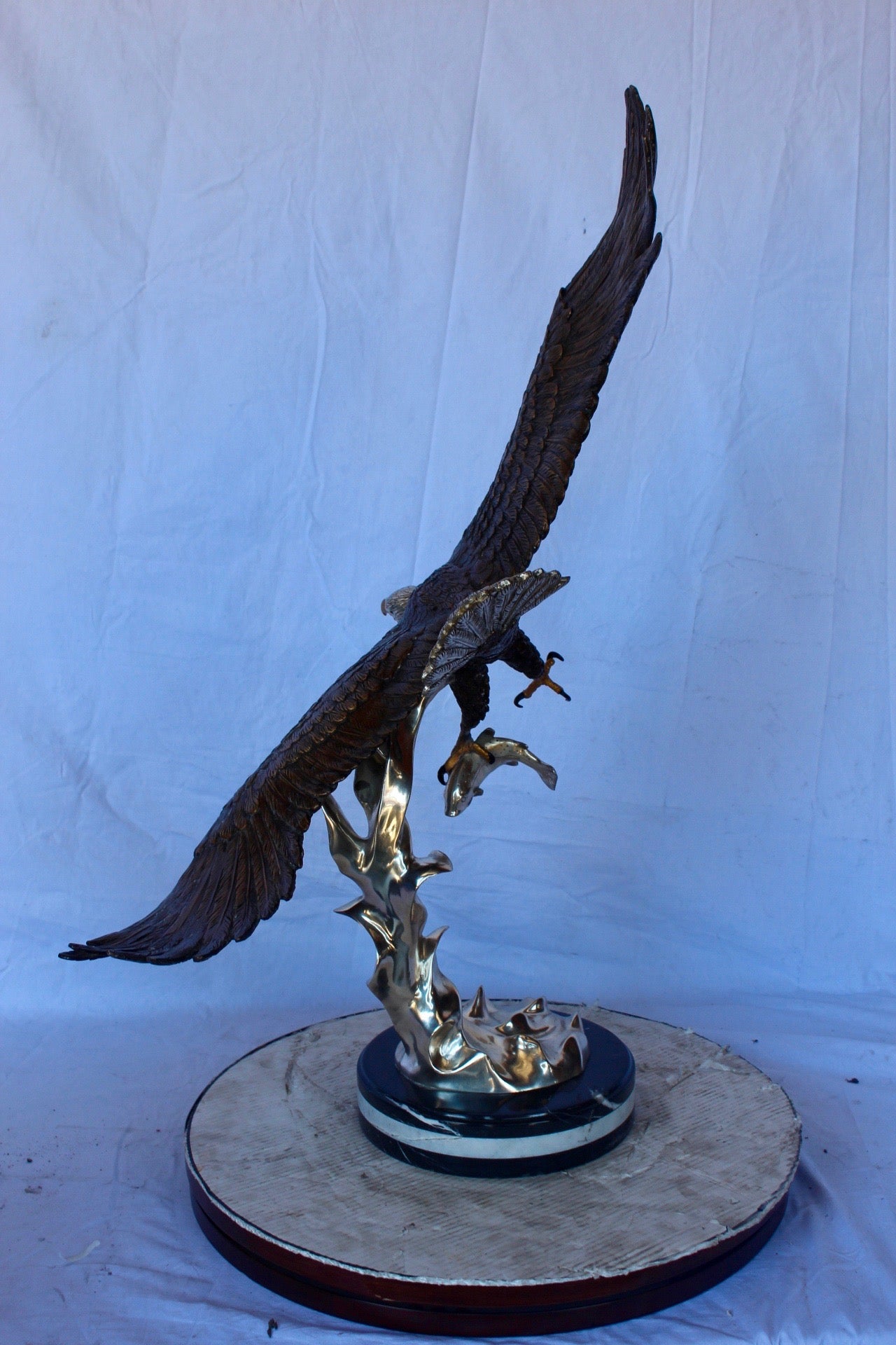 Soaring eagle carrying prey bronze statue -  Size: 16"L x 23"W x 39"H.
