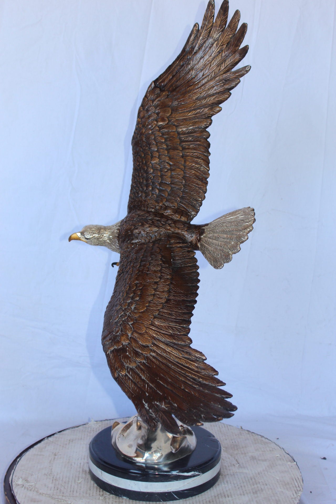 Soaring eagle carrying prey bronze statue -  Size: 16"L x 23"W x 39"H.