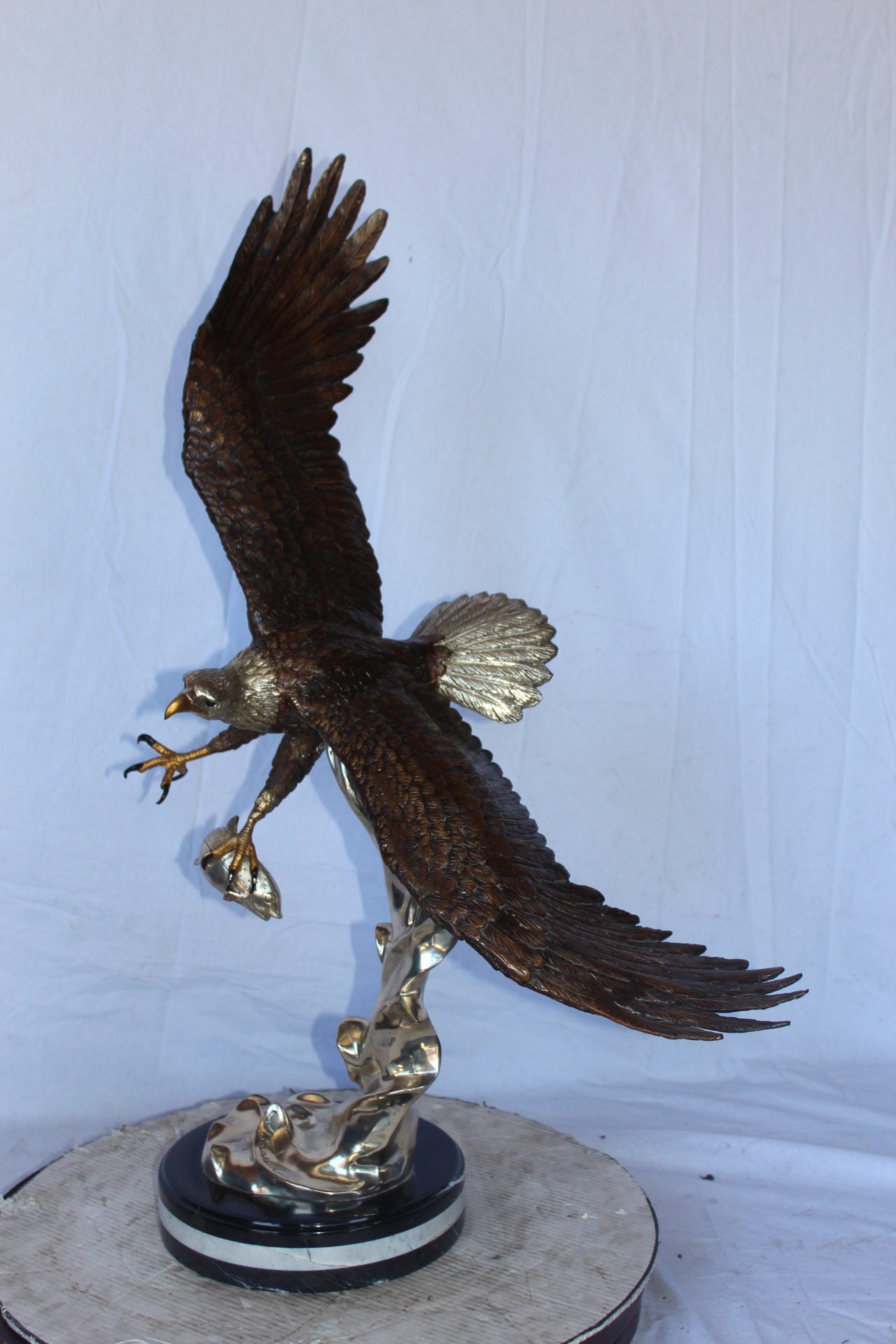 Soaring eagle carrying prey bronze statue -  Size: 16"L x 23"W x 39"H.