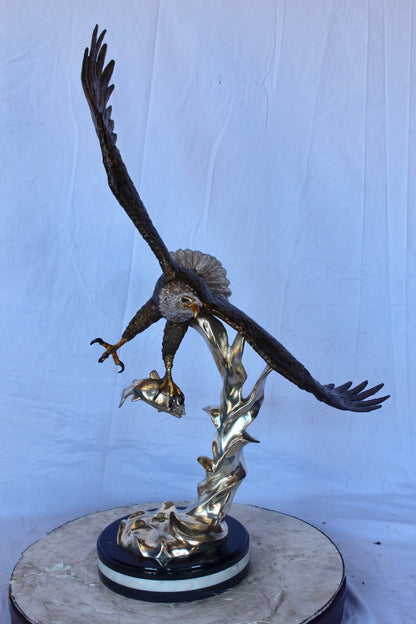 Soaring eagle carrying prey bronze statue -  Size: 16"L x 23"W x 39"H.