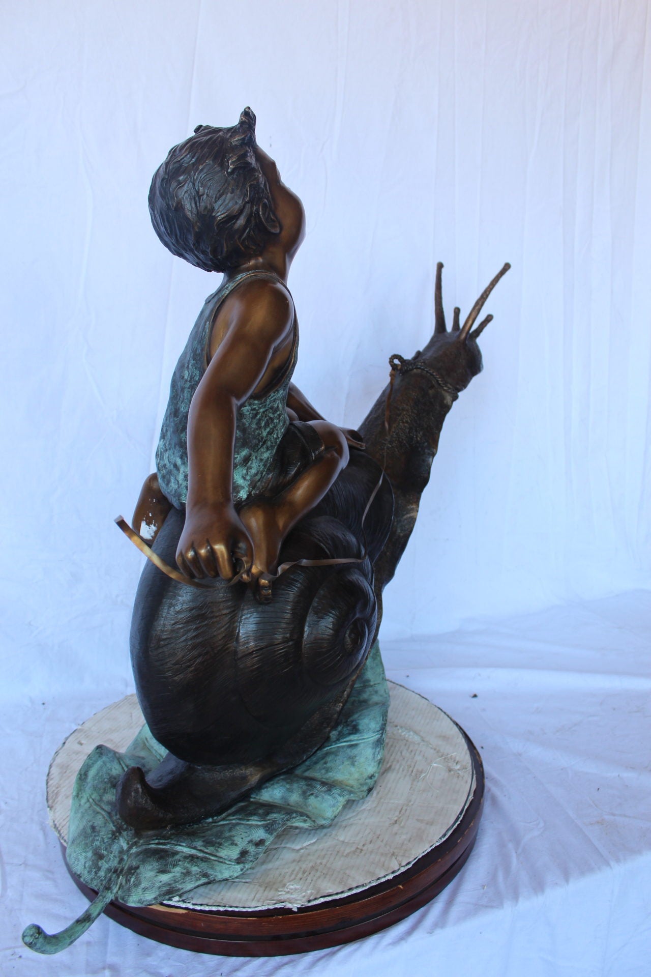 Happy boy riding a snail bronze statue fountain -  Size: 42"L x 14"W x 34"H.