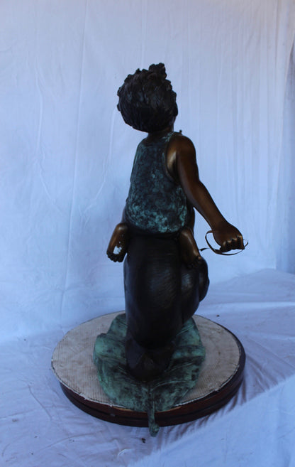 Happy boy riding a snail bronze statue fountain -  Size: 42"L x 14"W x 34"H.