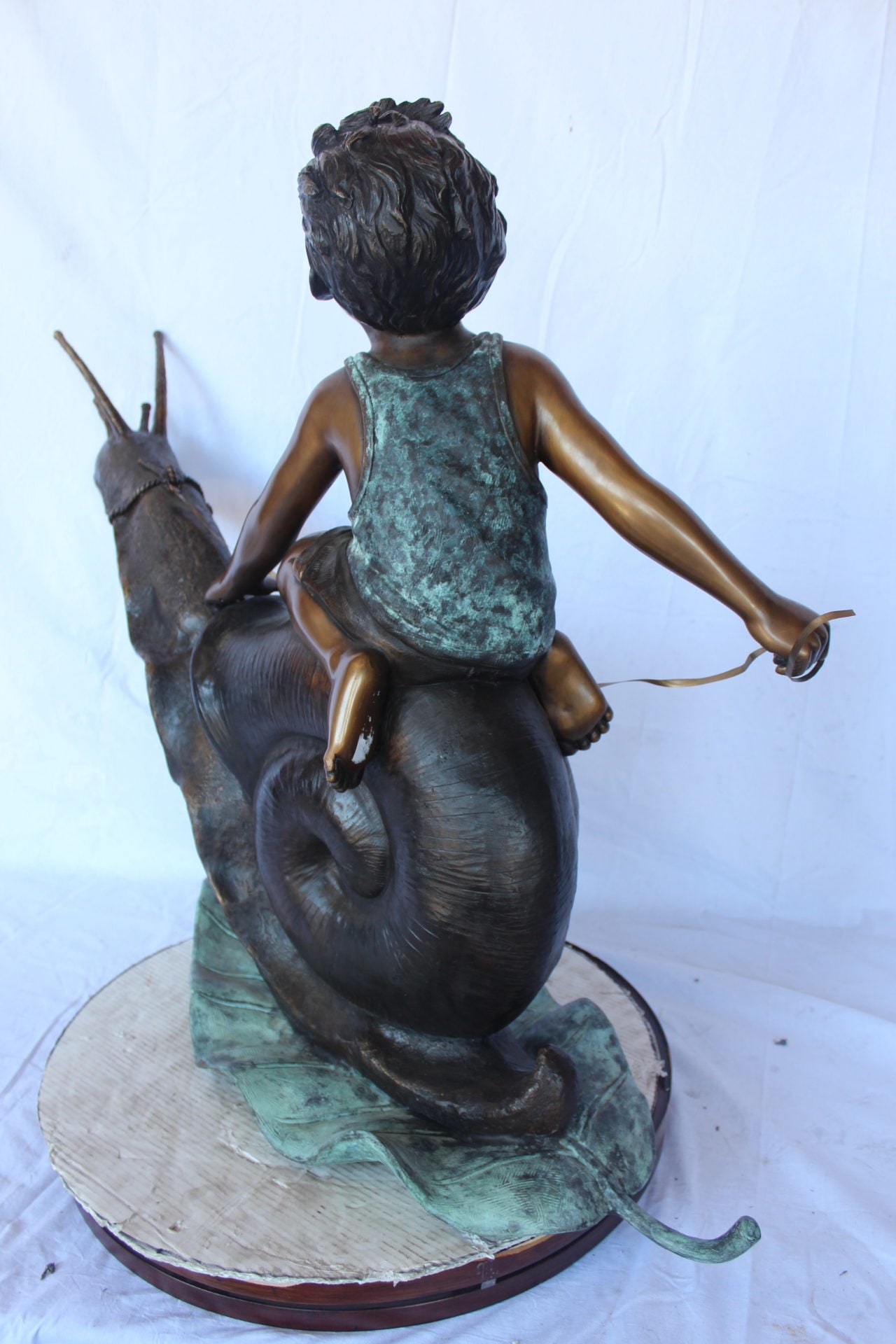 Happy boy riding a snail bronze statue fountain -  Size: 42"L x 14"W x 34"H.