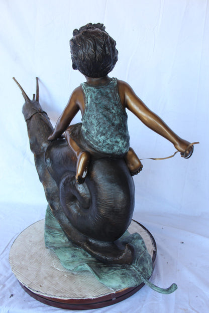 Happy boy riding a snail bronze statue fountain -  Size: 42"L x 14"W x 34"H.